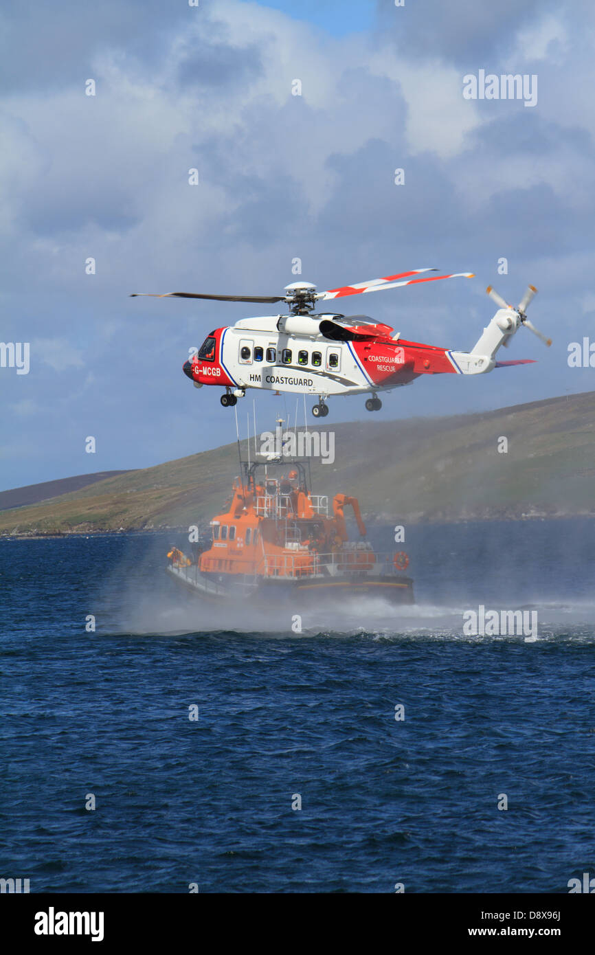 Un elicottero di guardia costiera e RNLI scialuppa di salvataggio pratica un salvataggio in mare Foto Stock