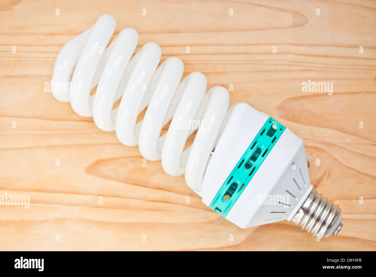 Luce a risparmio energetico la lampadina su pavimenti in legno Foto Stock
