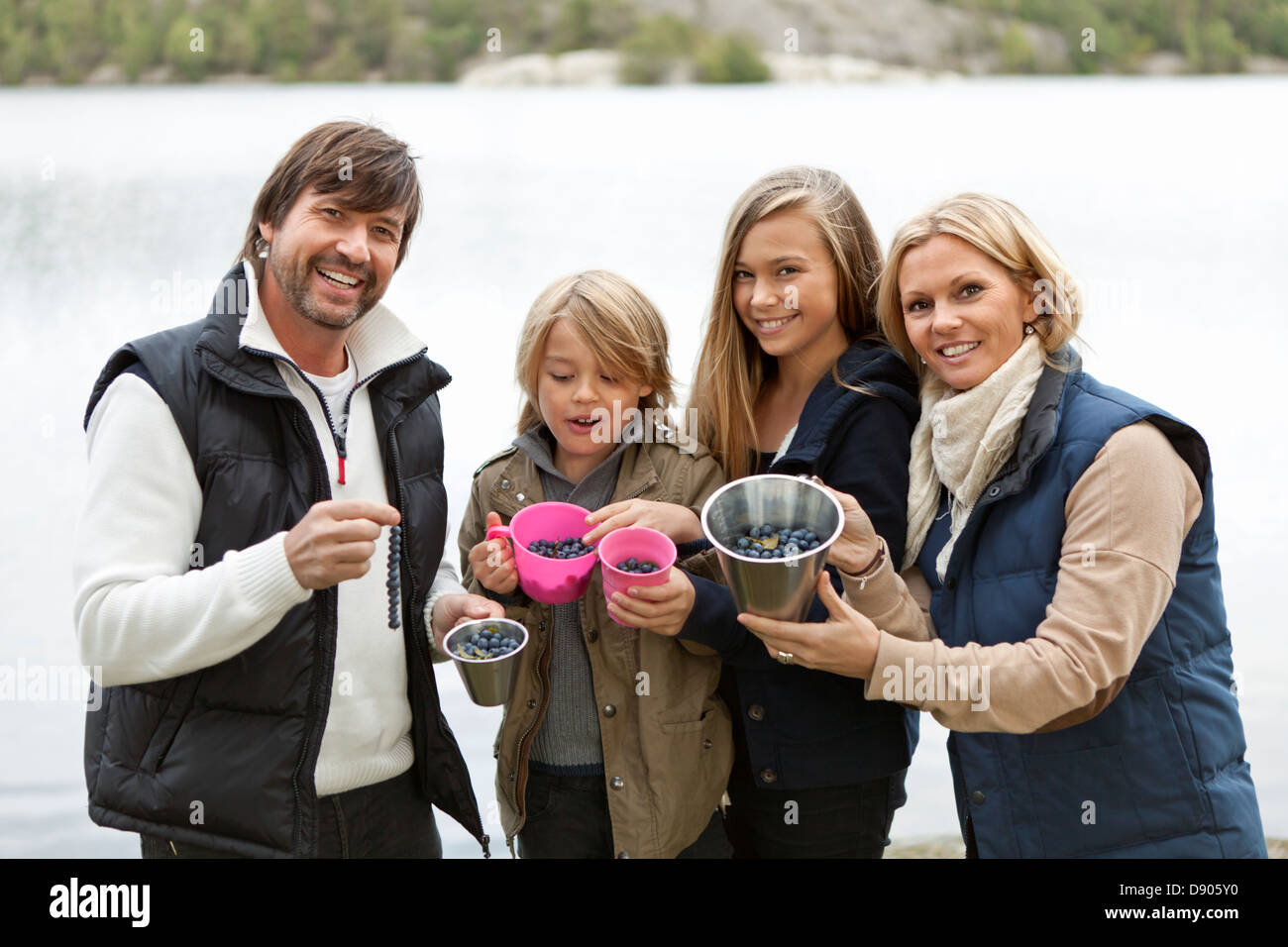 Famiglia con due bambini il prelievo di mirtilli Foto Stock