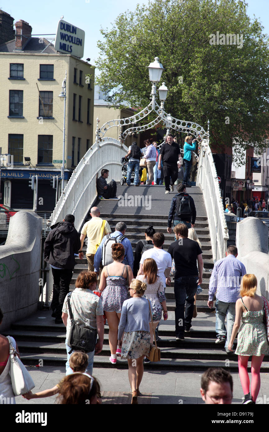 Beggar tra la folla sul ponte Halfpenny, Dublino, Irlanda Foto Stock