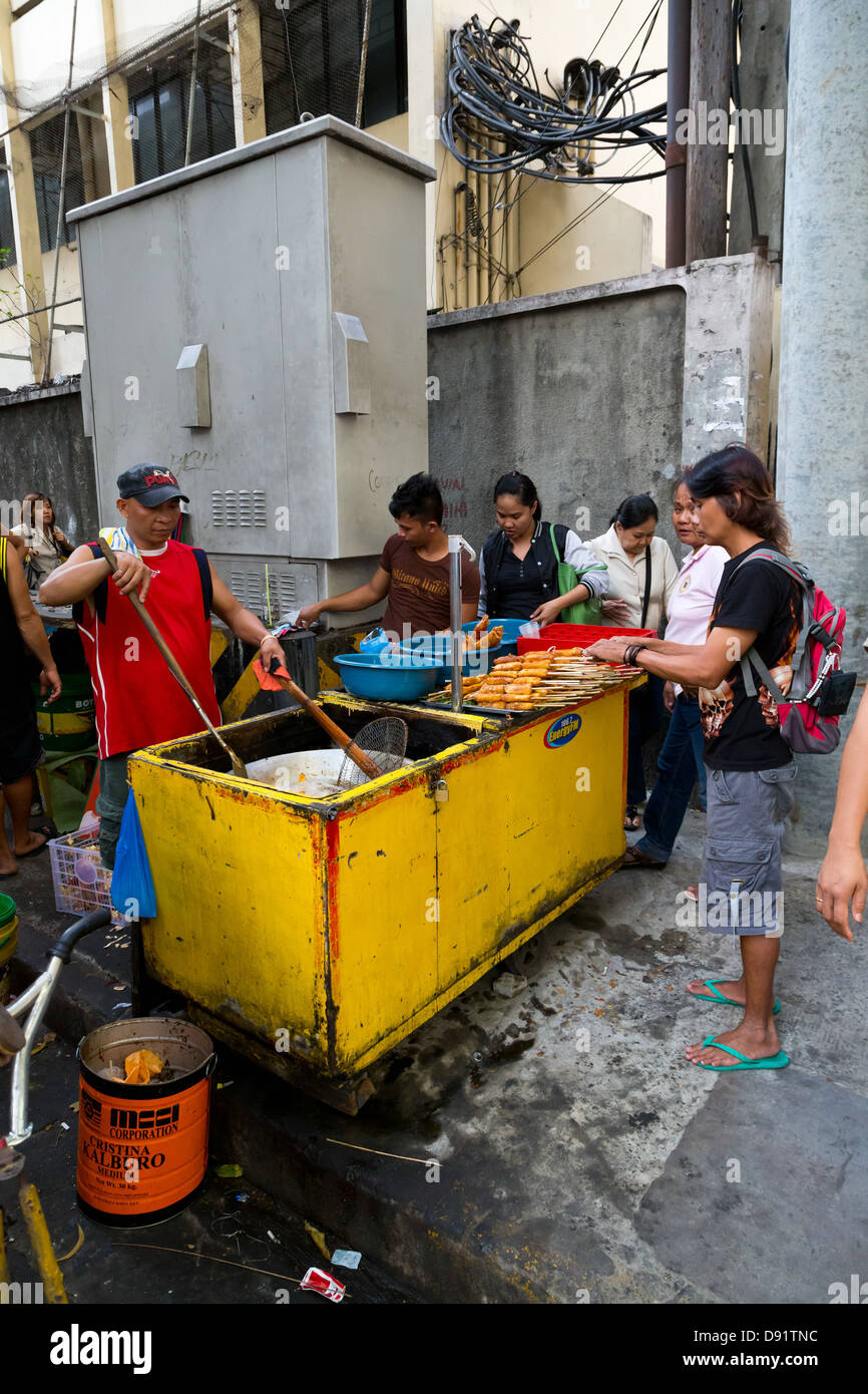 La vendita di cibo di strada a Manila nelle Filippine Foto Stock