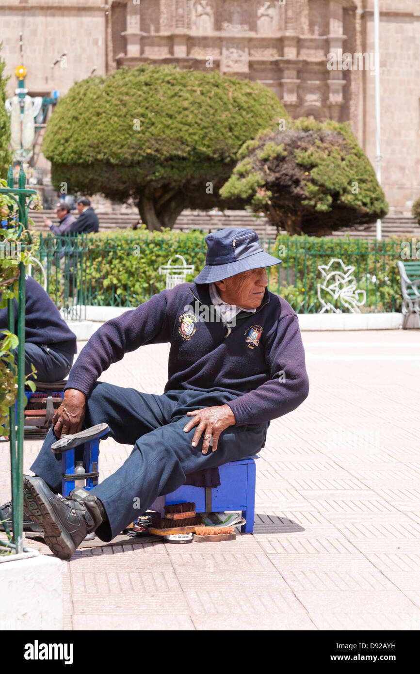 Lustrascarpe uomo, Plaza de Armas, Puno, Perù Foto Stock