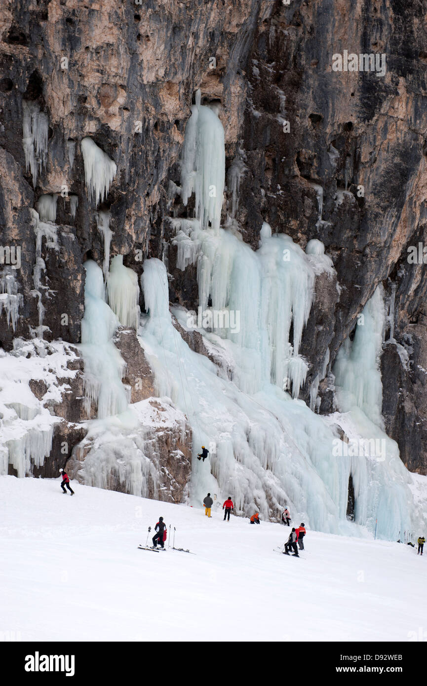 Gli sciatori osservare ice climber su roccia al Lagazuoi, Alto Adige, Italia Foto Stock