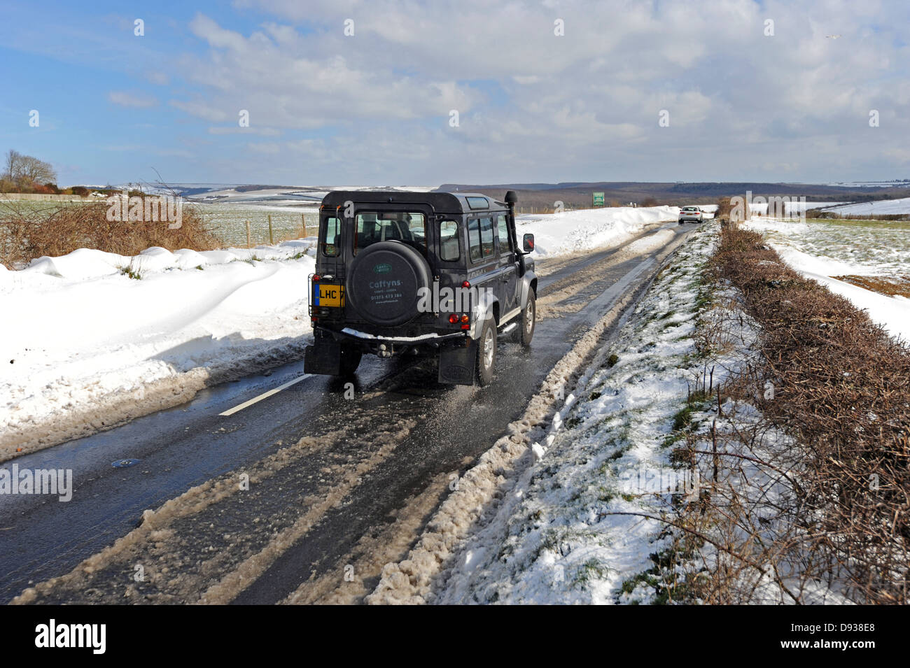 Un Land Rover fissi sulla strada dopo una nevicata sulla Sussex Downs Foto Stock