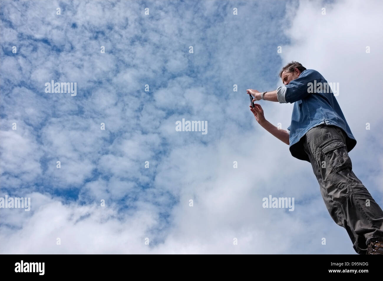 Un uomo su una collina prendere una fotografia Foto Stock
