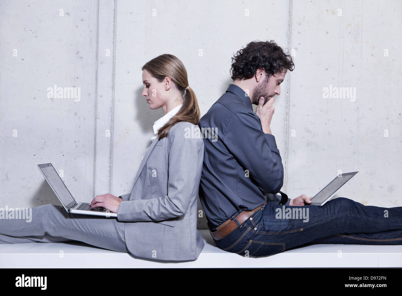 In Germania, in Renania settentrionale-Vestfalia, Colonia, Businesscouple utilizzando laptop e tablet digitale Foto Stock