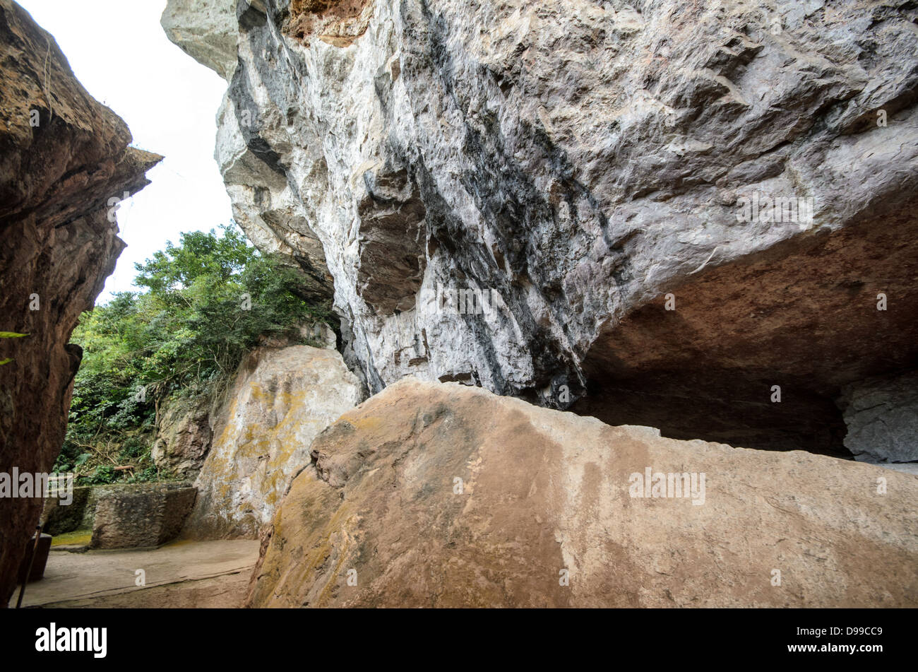 VIENG XAI, Laos - Un ingresso nascosto conduce al complesso di grotte di Pathet Lao a Vieng Xai, una rete di grotte calcaree che serviva come quartier generale e rifugio per le forze comuniste Pathet Lao durante la seconda guerra d'Indocina dal 1964 al 1973. Le grotte fornirono rifugio a migliaia di persone, compresi i leader politici, durante la vasta campagna di bombardamenti degli Stati Uniti nota come Guerra segreta. Questo sistema di grotte ospitava scuole, ospedali, teatri e uffici governativi, creando una città sotterranea che permetteva al Pathet Lao di continuare le operazioni evitando gli attacchi aerei. Il Vieng Foto Stock