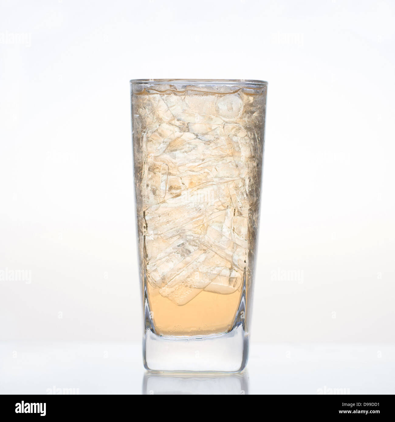 Il dolce succo di mela con ghiaccio in vetro isolato su sfondo bianco Foto Stock