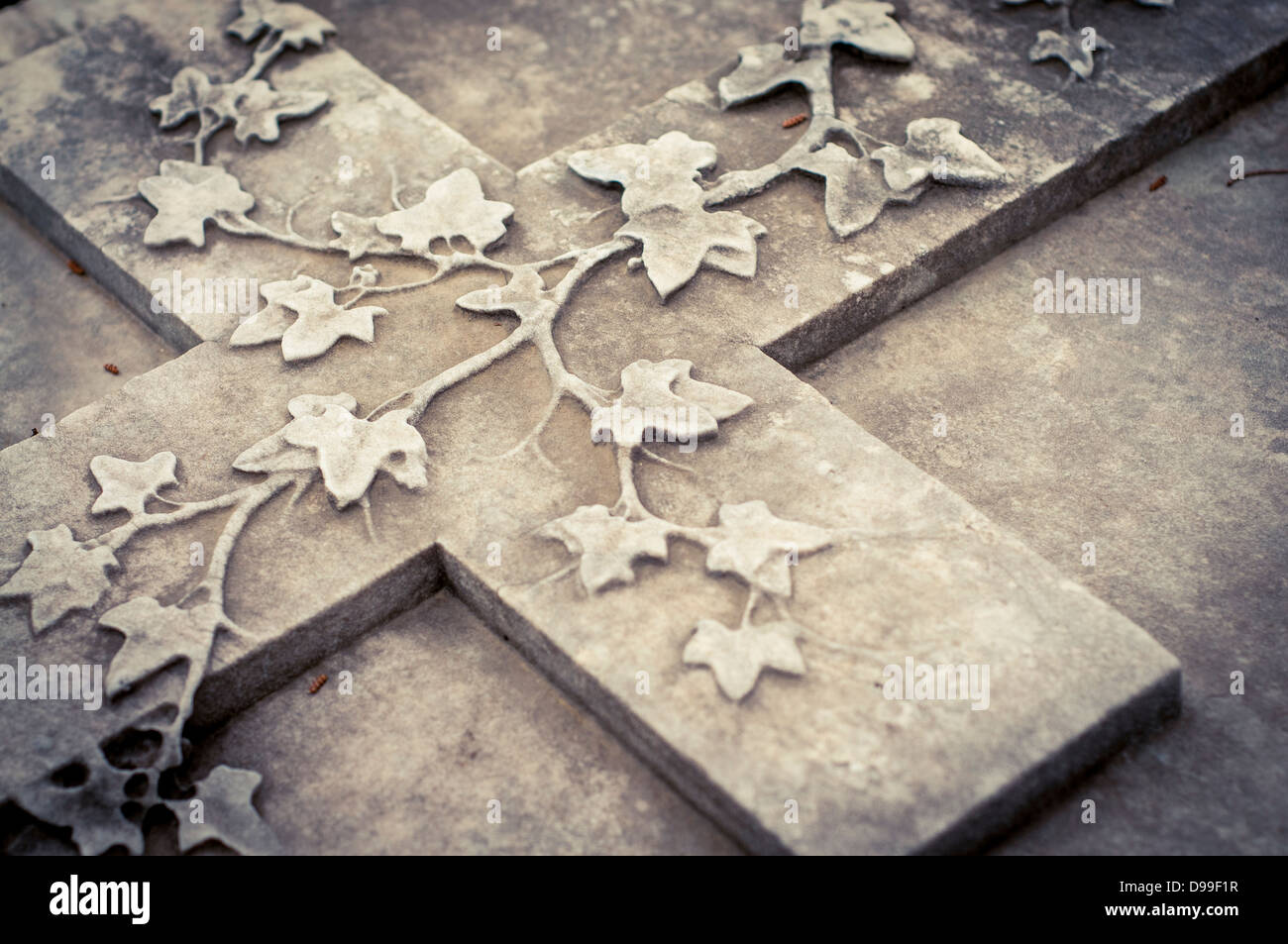 Una croce di pietra con foglie di vite su una lastra tombale al Cimitero degli Inglesi, Firenze, Italia Foto Stock