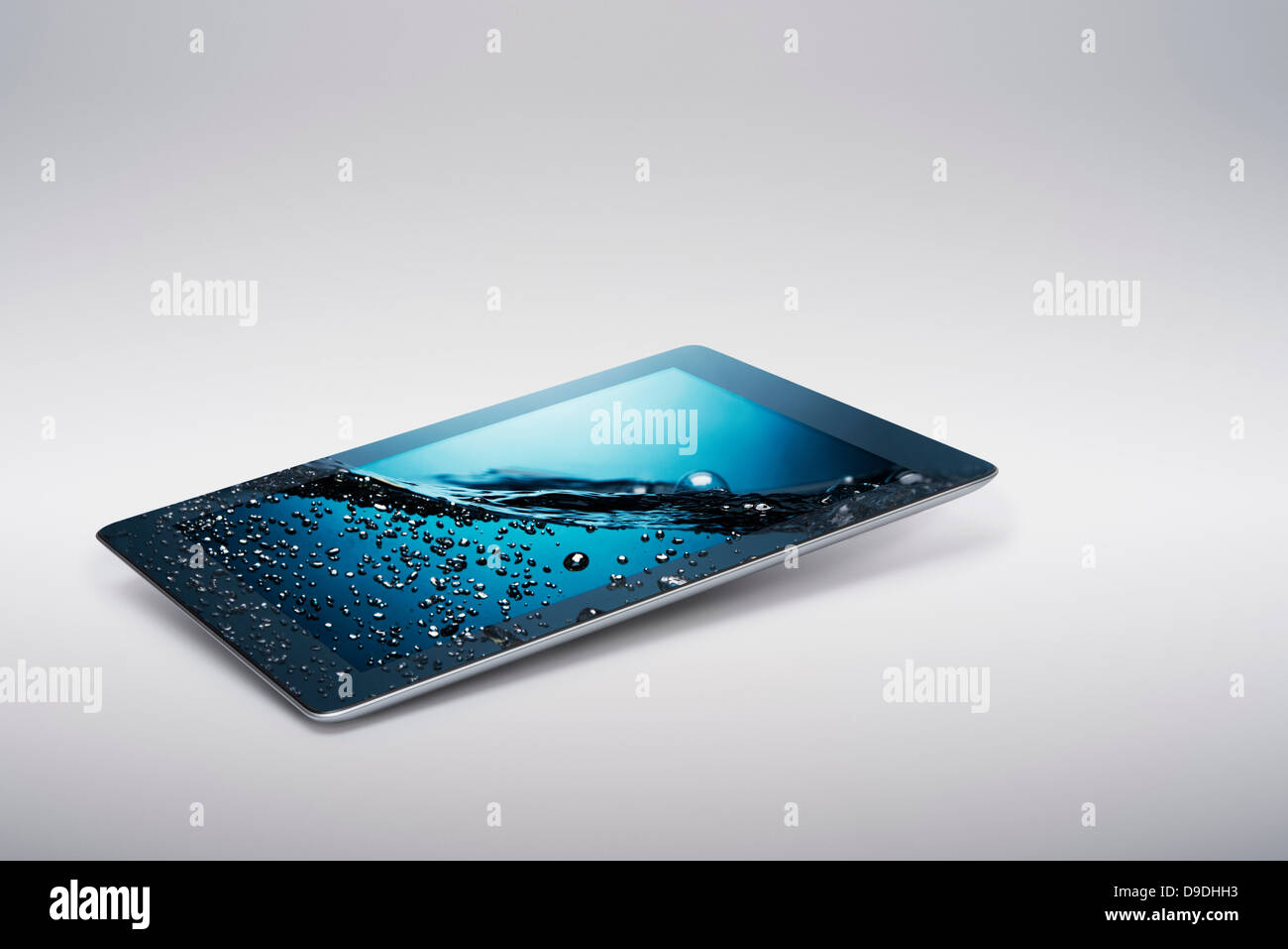 Tavoletta digitale con salita delicatamente gorgogliamento di acqua sullo schermo Foto Stock