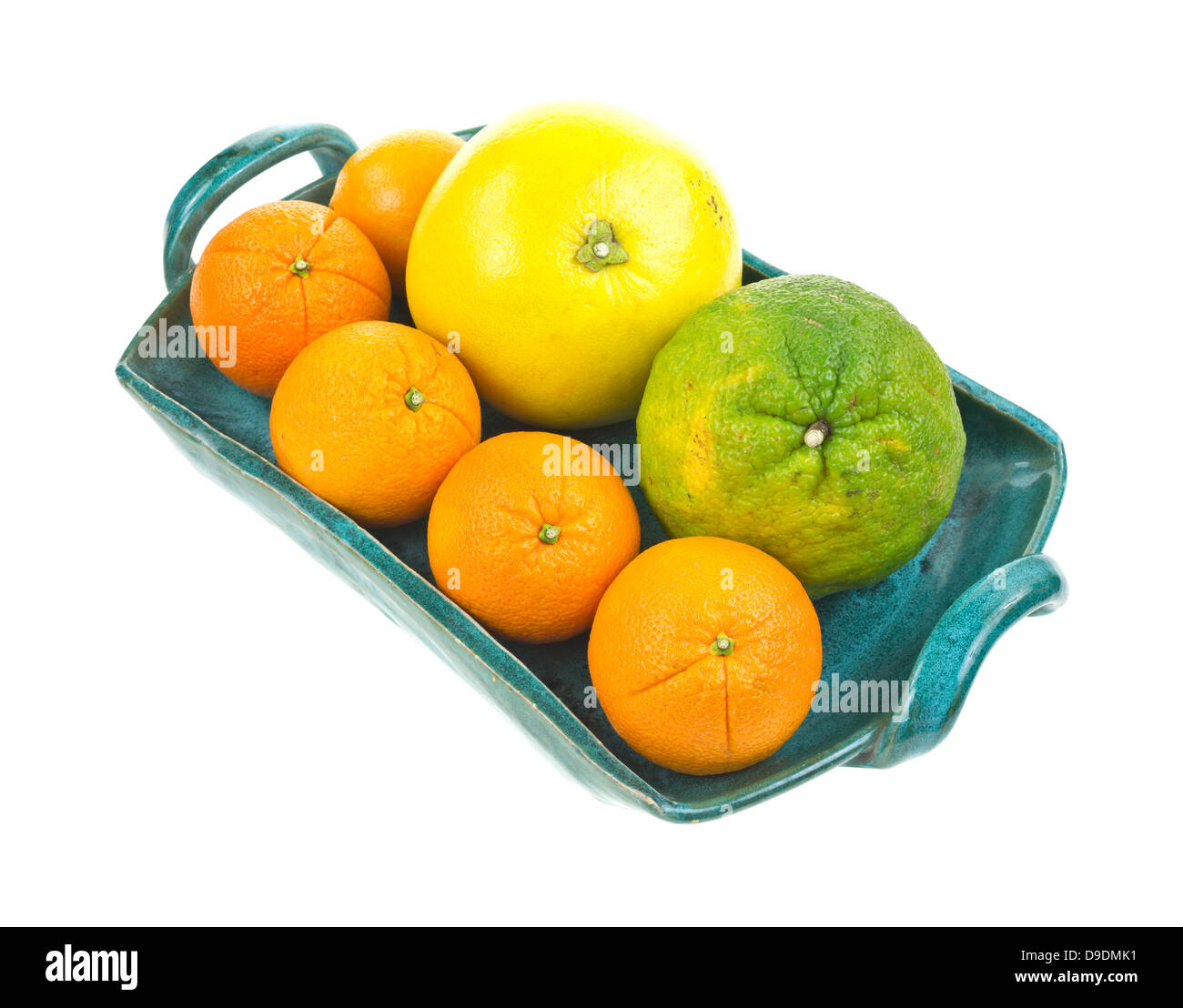 Un uniq, pomelo, e diverse le arance in una vendemmia verde in ceramica trattate vassoio. Foto Stock