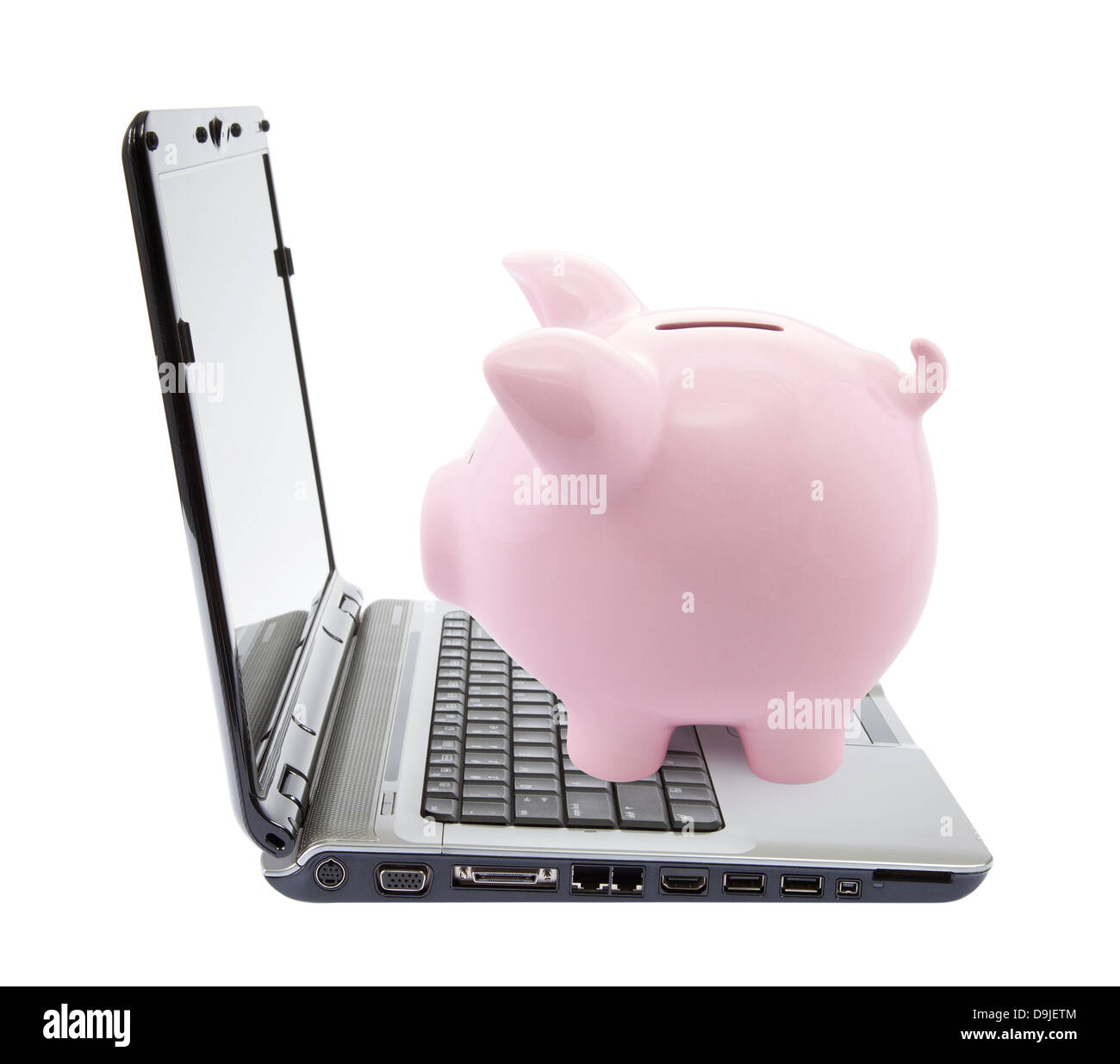 Salvadanaio e il computer portatile isolato su bianco Foto Stock Salvadanaio e il computer portatile isolato su bianco Foto Stock