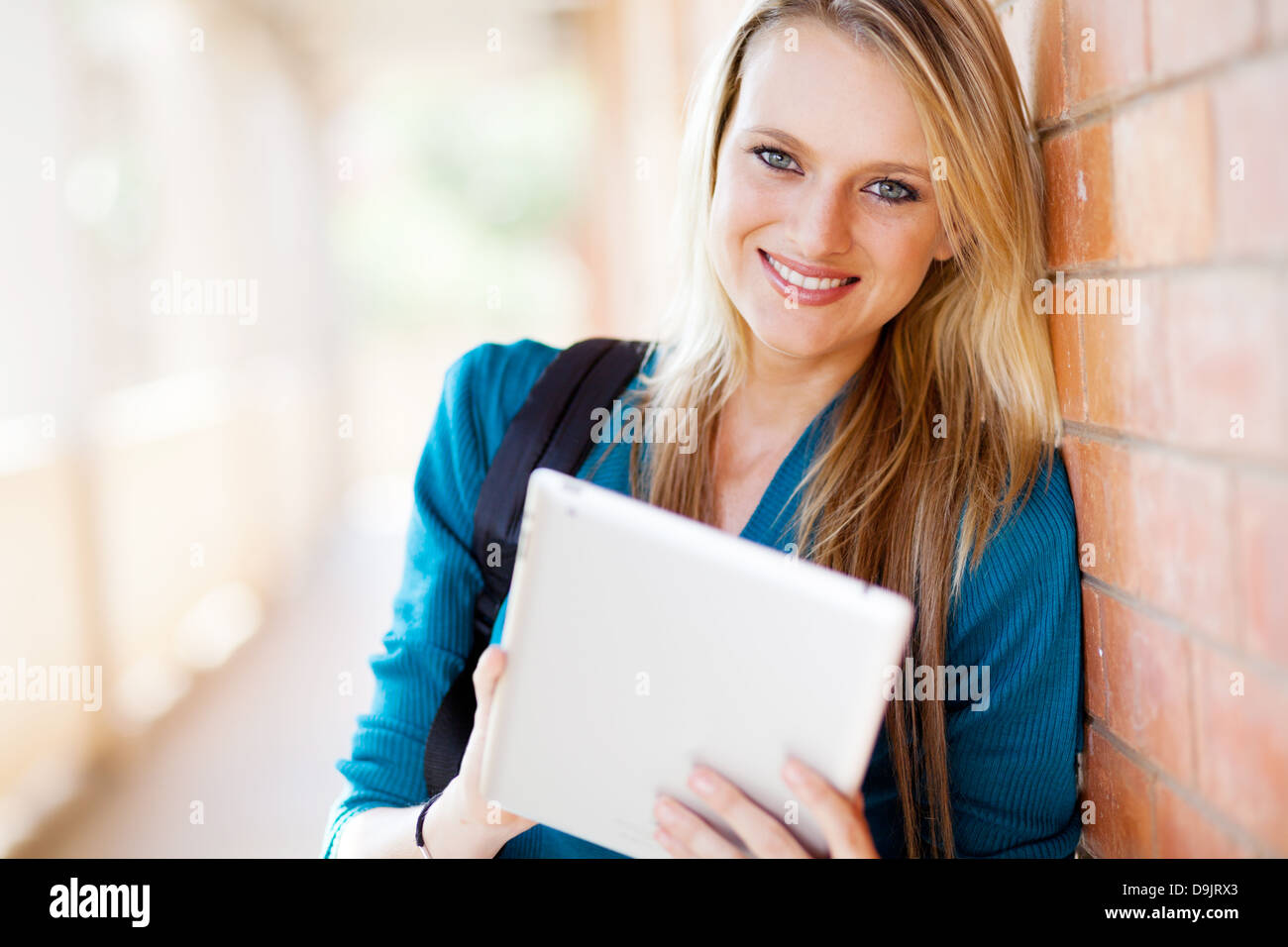 Attraente femmina giovane studente universitario utilizzando computer tablet Foto Stock