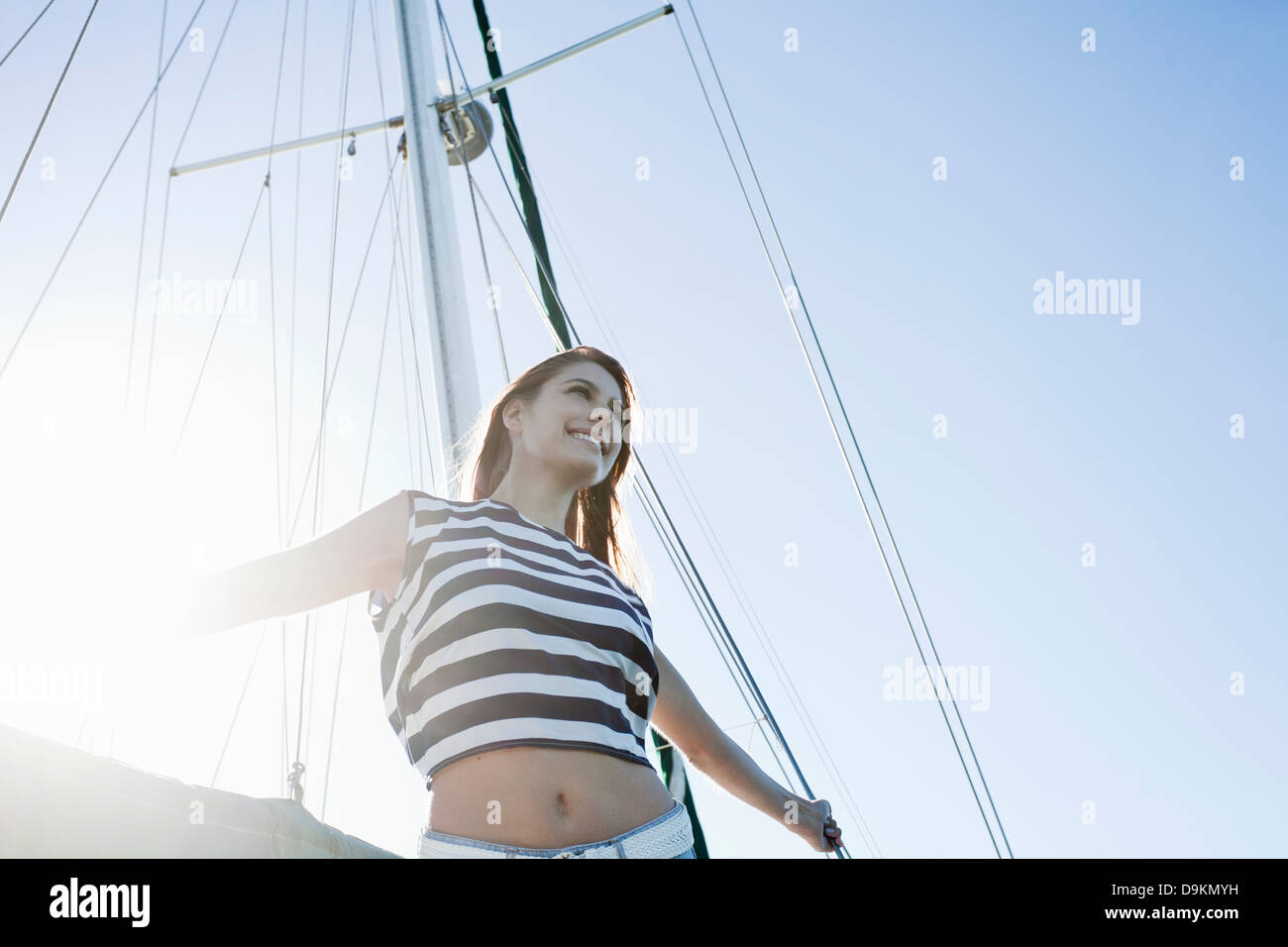 Giovane donna su yacht indossare top a strisce Foto Stock