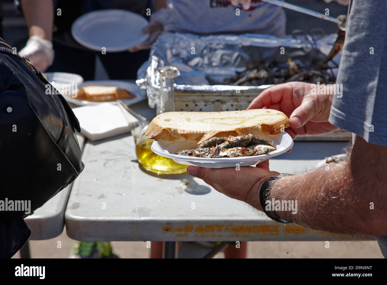 Open day presso il fishermans servendo collettiva cucinato al momento di sardine Port Harbour di Cambrils Catalogna Spagna Foto Stock