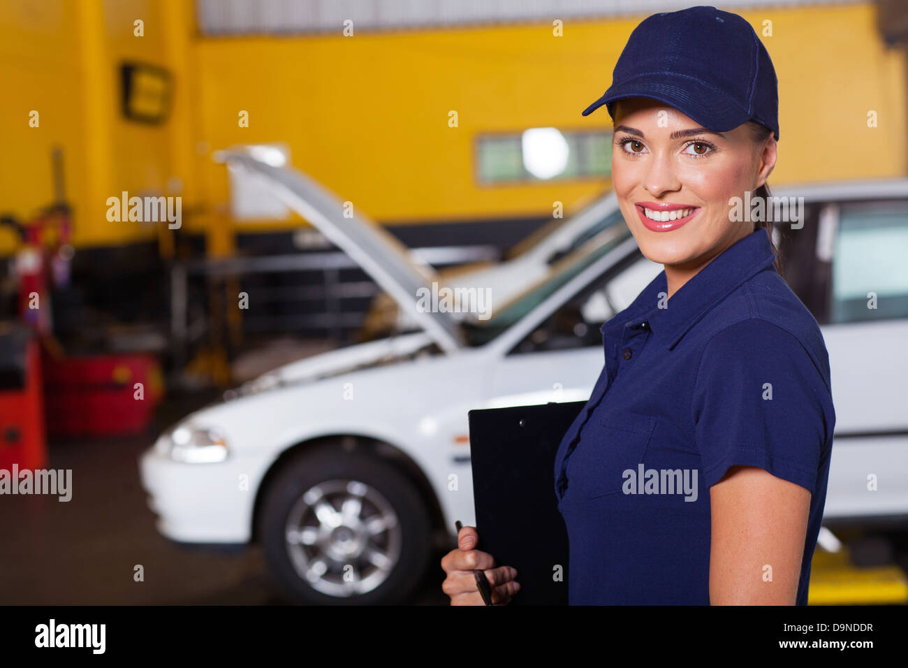 Bella femmina allegro auto garage manager ritratto all'interno della officina Foto Stock