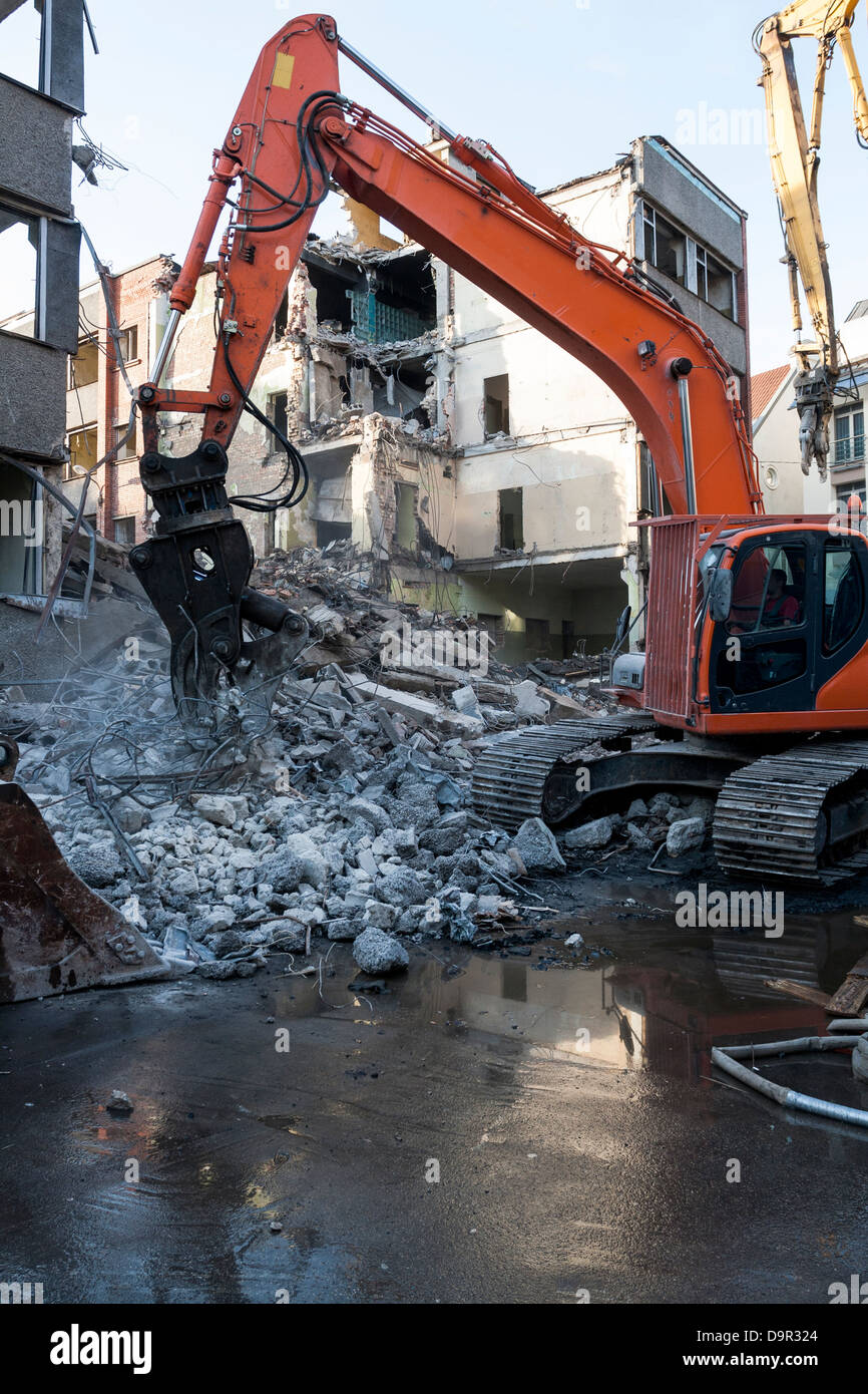 Demolizione di un vecchio edificio con macchinari pesanti per la nuova costruzione Foto Stock