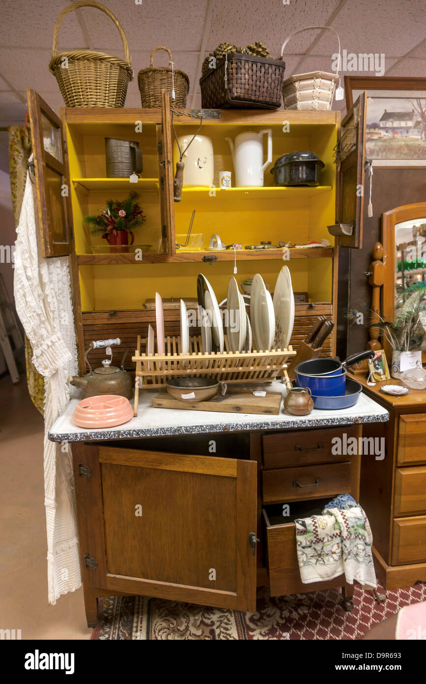 Vintage piatti, pentole, padelle, i cestini e gli accessori visualizzati su una compatta free-standing mobile da cucina. Foto Stock