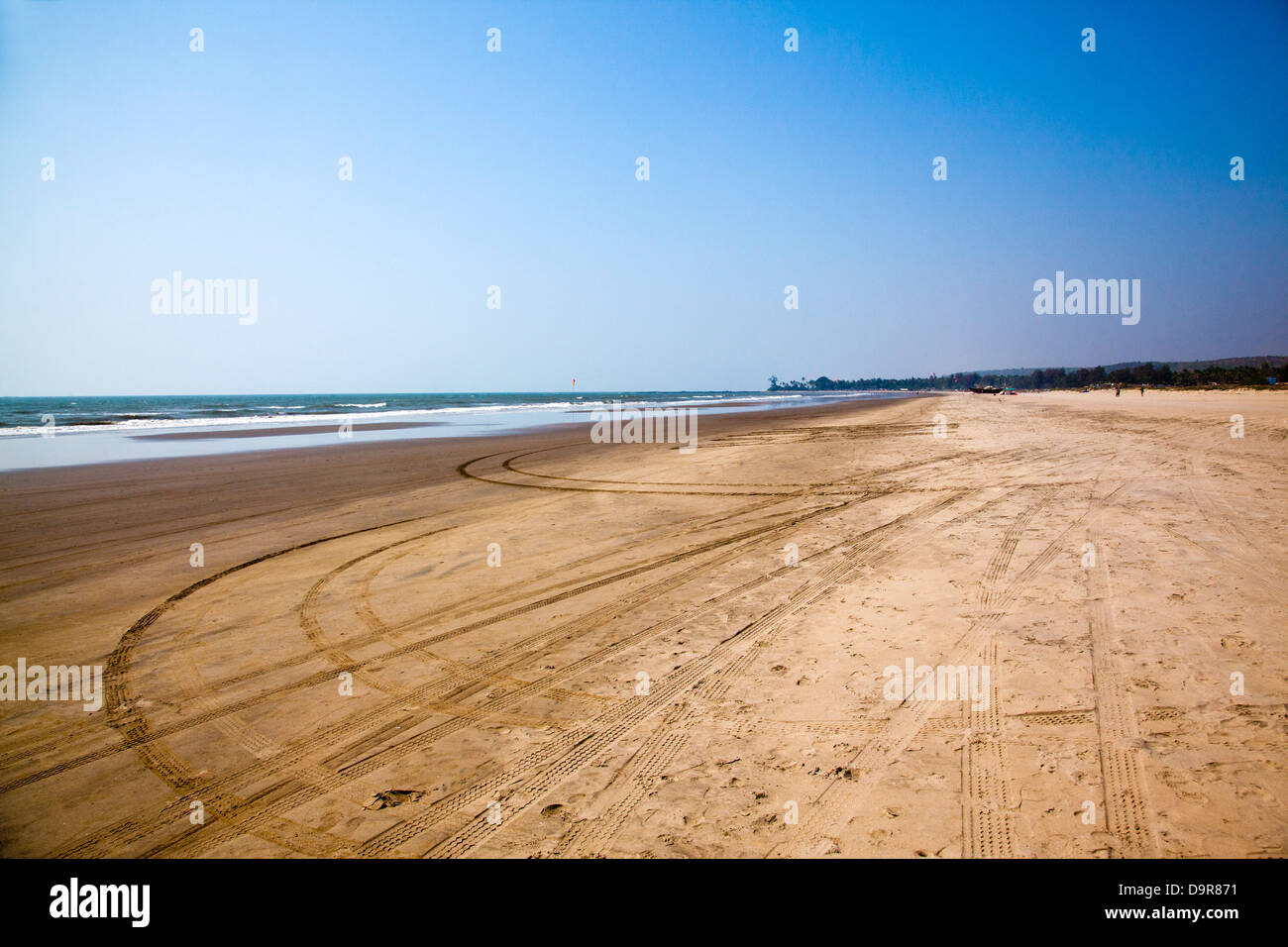 Tracce di pneumatici e di impronte sulla spiaggia, Morjim, Pernem, Goa, India Foto Stock