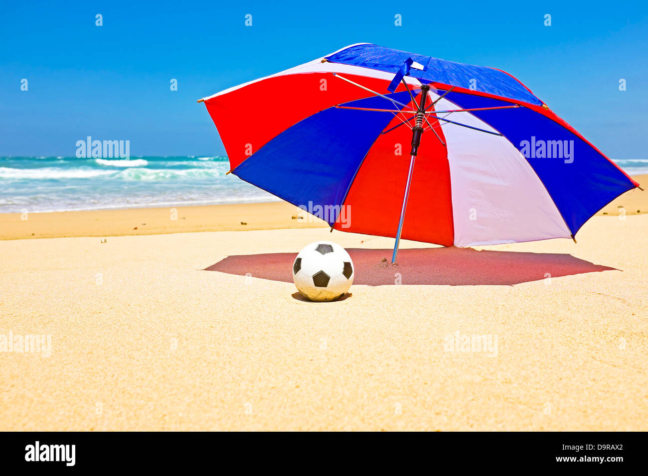 Ombrellone con sfera in spiaggia Foto Stock