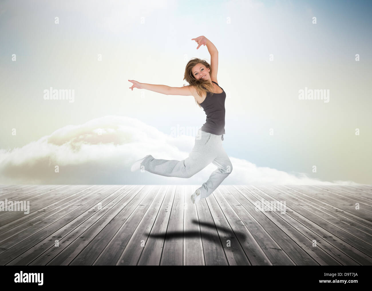 Donna saltando su tavole di legno Foto Stock
