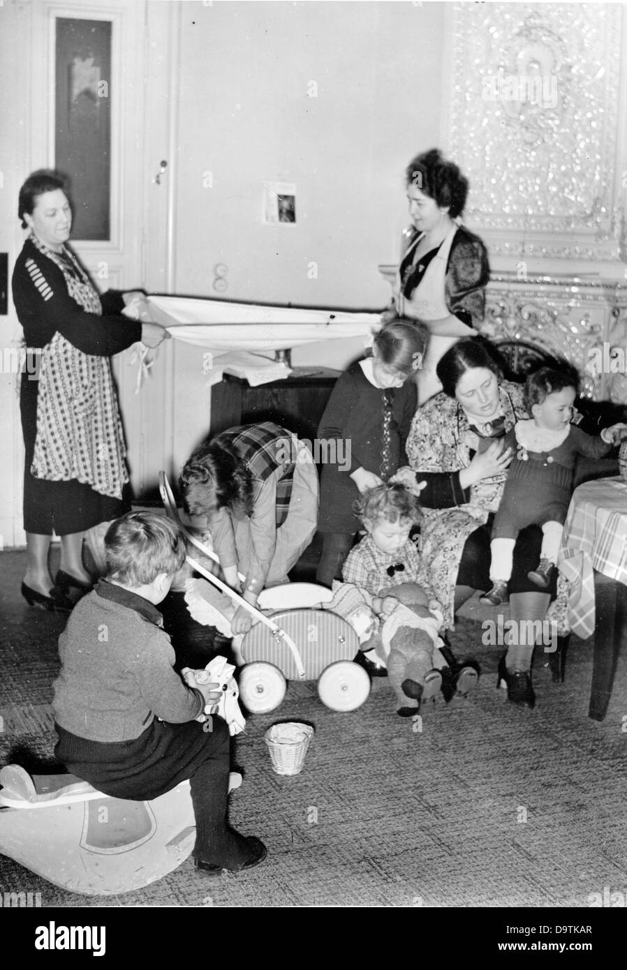 Testo di propaganda del socialista nazionale che riporta sul retro del quadro: "Le donne tedesche sono sempre entusiaste. (Foto dall'assistenza di quartiere). La madre ha un sacco di lavoro con i suoi molti figli. Può prendersi cura di loro senza preoccupazioni perché due donne vicine le fanno le pulizie per lei". Foto del 25 marzo 1941. Luogo sconosciuto. Fotoarchiv für Zeitgeschichte Foto Stock