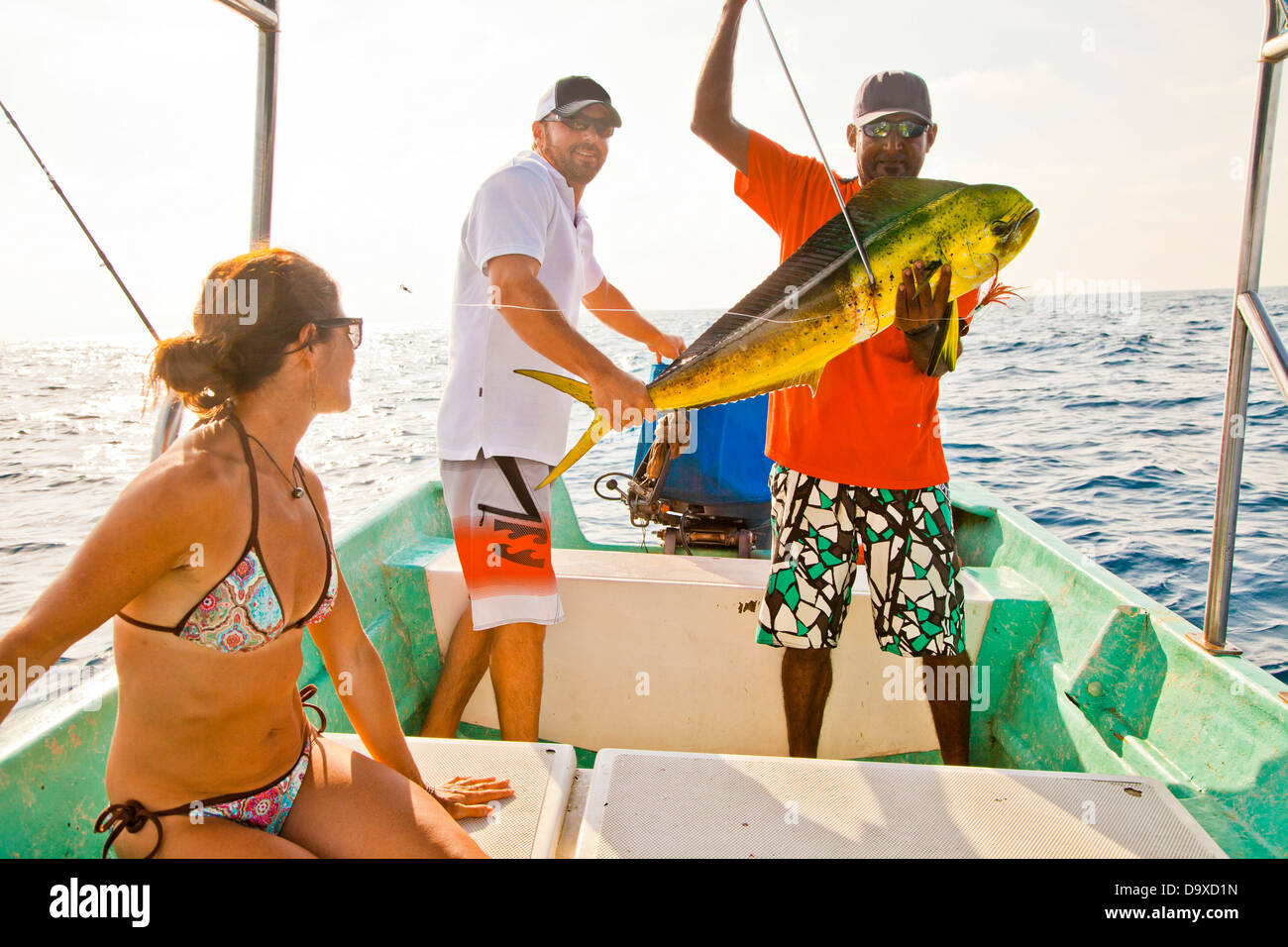 Tre persone su carta la pesca in barca Foto Stock