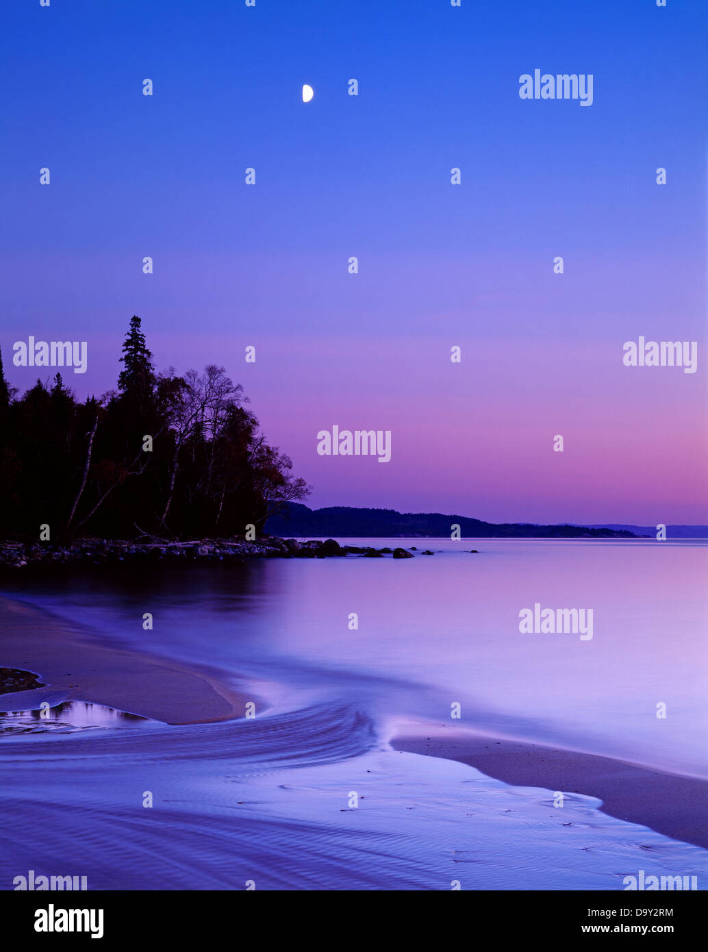 Quarto di luna con il tramonto scendere sul lago Superiore, Lago Superior parco provinciale, Ontario, Canada. Foto Stock