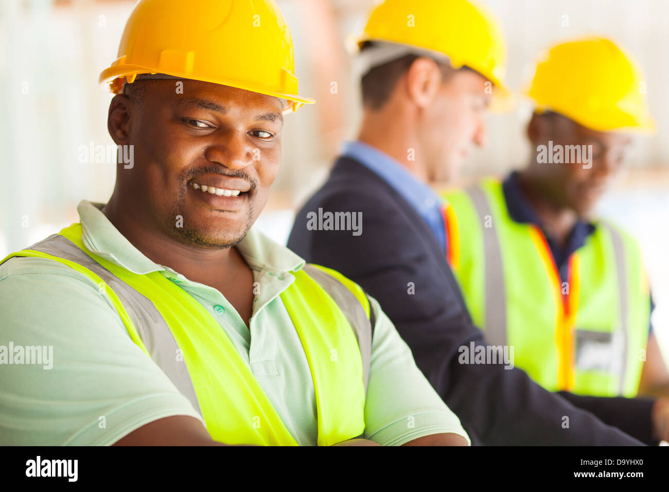 Sorridente africana di ingegnere industriale con i colleghi Foto Stock