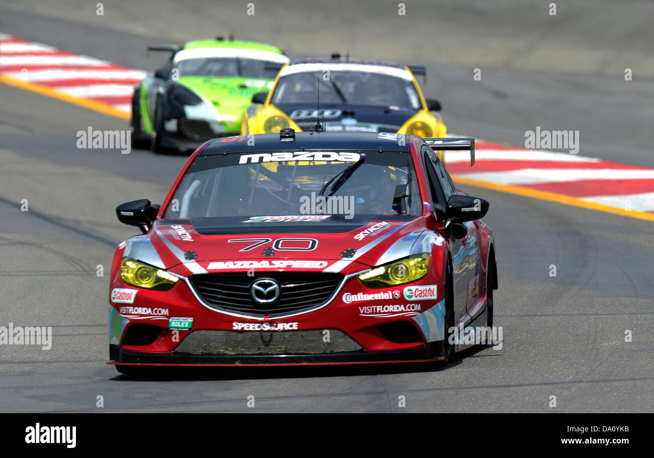 Giugno 30, 2013 - Watkins Glen, New York, Stati Uniti d'America - 30 Giugno 2013: Il SpeedSource Mazda RX-8 (70) pilotato da Jonathan Bomarito e Sylvain Tremblay e Tom conduttore lungo una coppia di autovetture in giro 2 durante il Grand-AM Rolex Sahlen serie di sei ore di Glen a Watkins Glen International in Watkins Glen, New York. Foto Stock