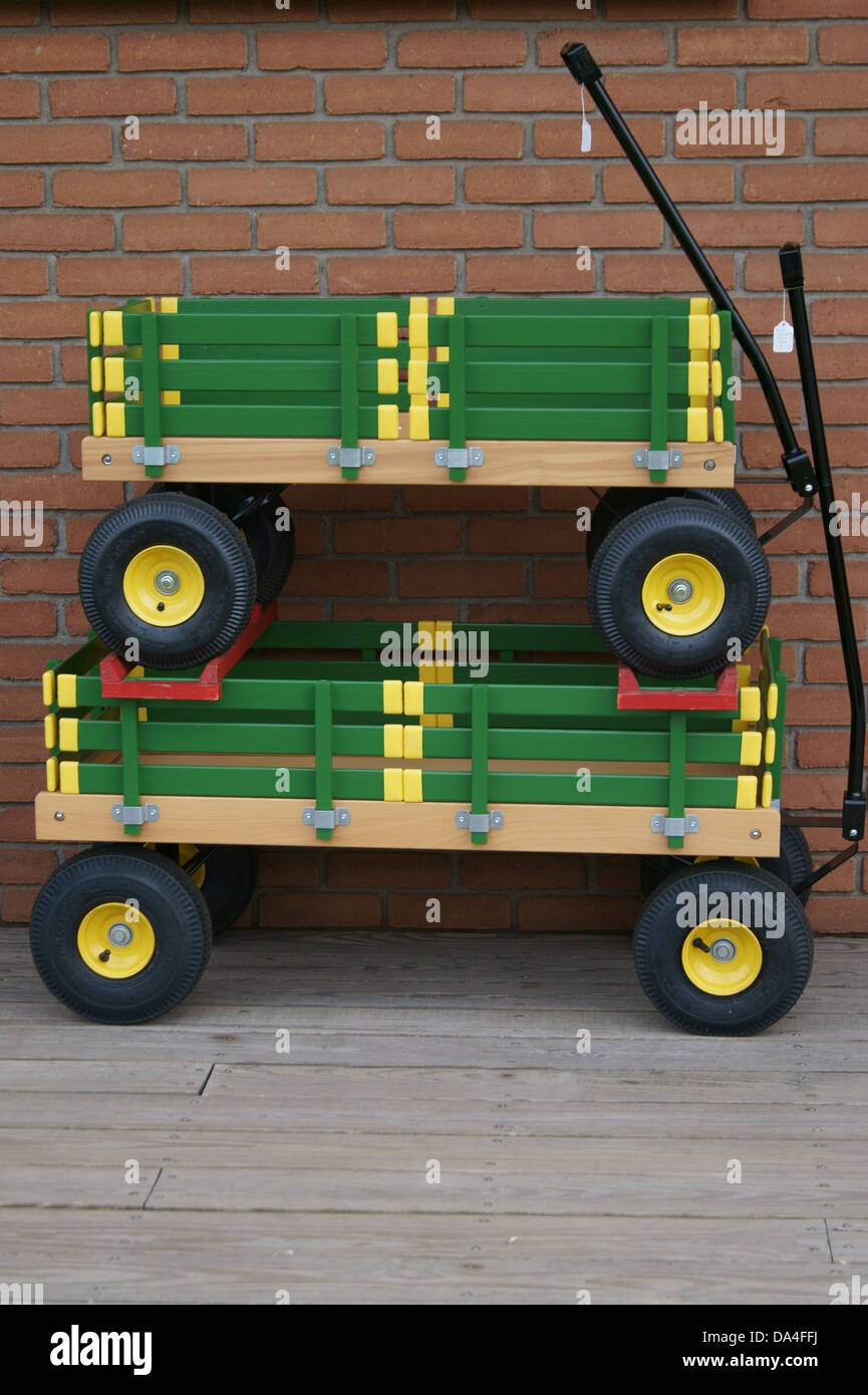 Due verde e giallo carri utilizzati per i giocattoli per bambini o per il trasporto. Foto Stock