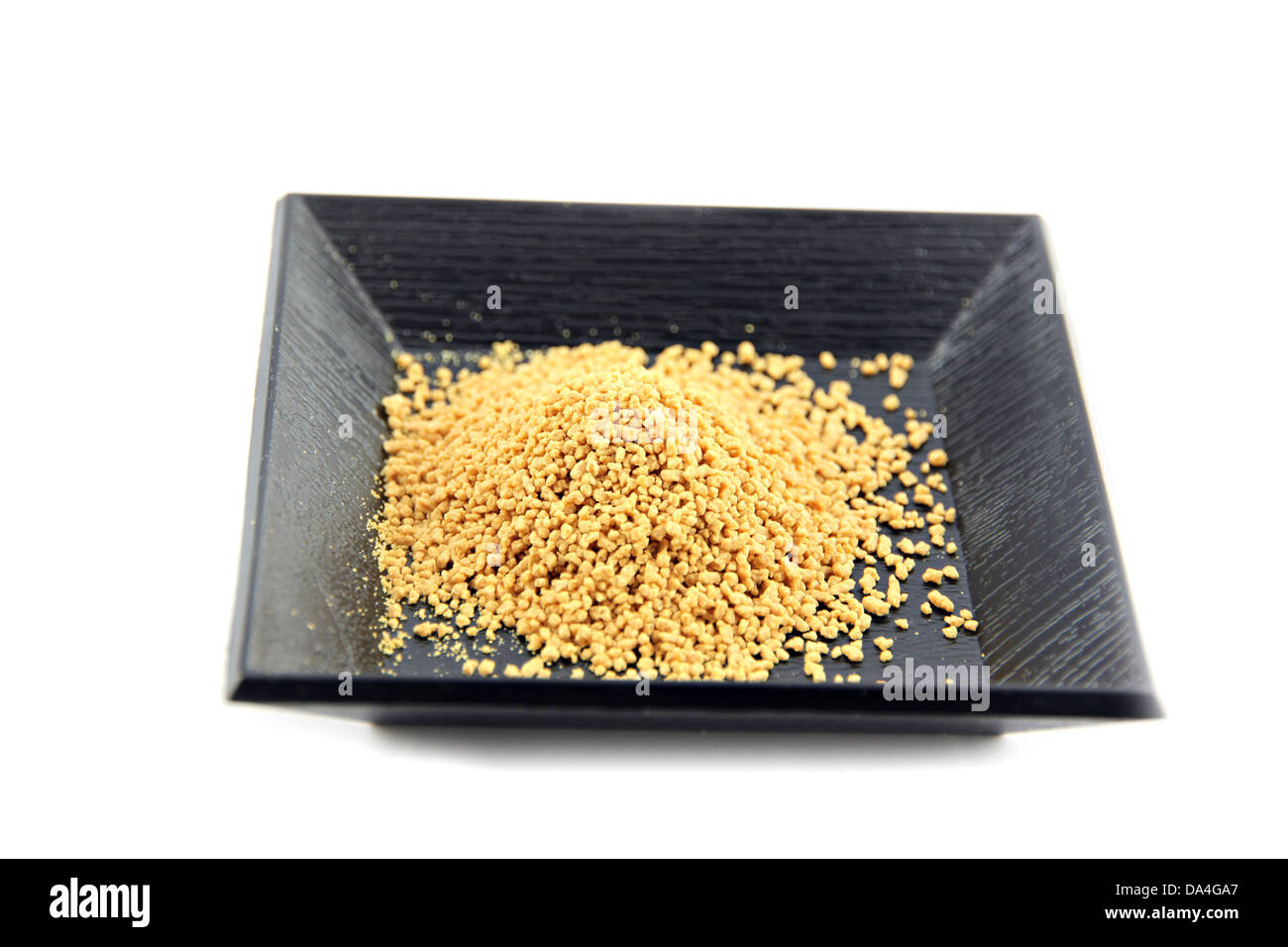 Lo zenzero in polvere in piatto nero su uno sfondo bianco. Foto Stock