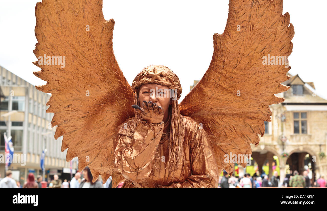 Angelo custode artista di strada statua vivente soffia un bacio, Peterborough, Inghilterra Foto Stock