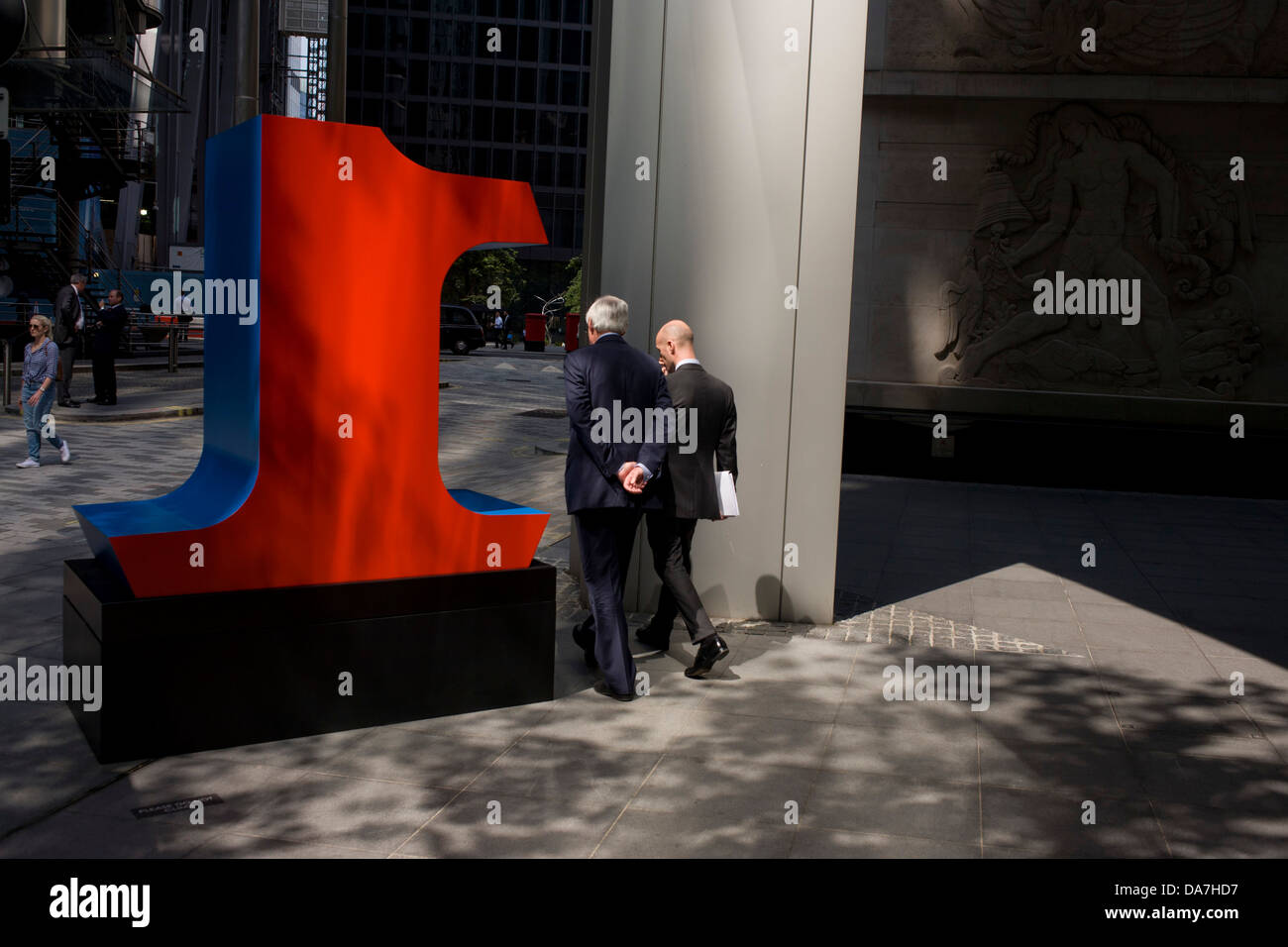 I lavoratori della città passa da un grande numero uno, parte di un arte di installazione intitolata "uno a zero (i dieci numeri)' da American pop artista Robert Indiana (b 1928), in Lime Street, Città di Londra, capitale Square Mile, e il suo cuore finanziario. Foto Stock