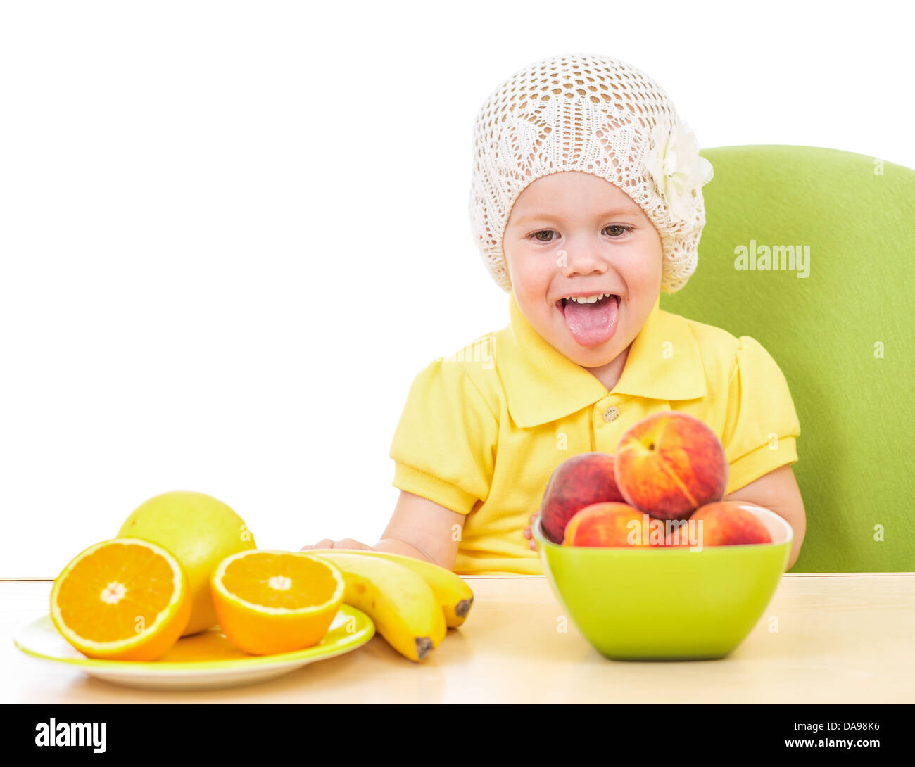 Bambina con cibo sano seduta a tavola isolato su bianco Foto Stock