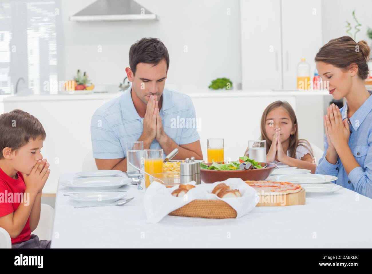 Famiglia dire grazia prima di cena Foto Stock