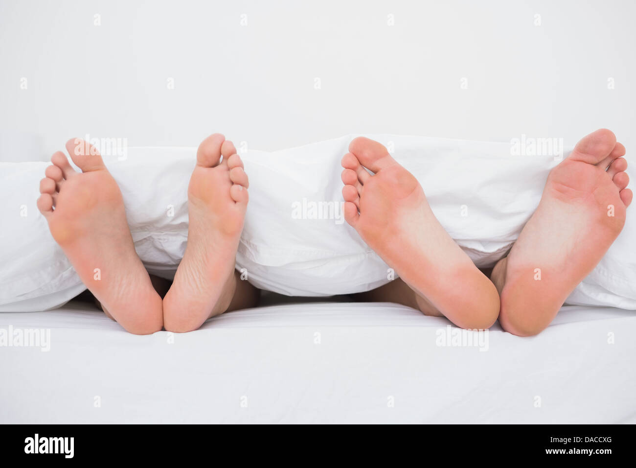 I piedi di un giovane a letto Foto Stock