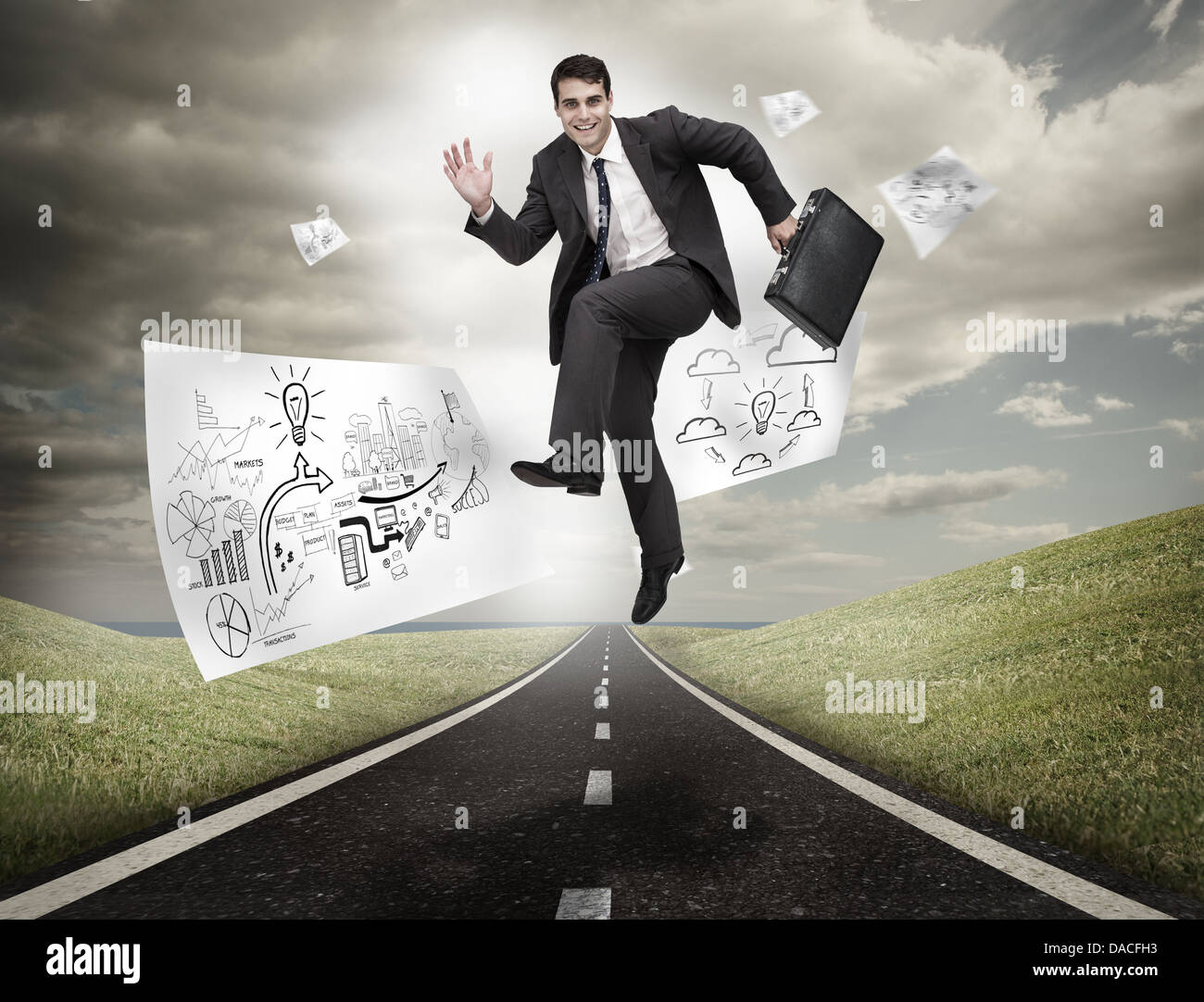 Imprenditore saltando su una strada con disegni floating Foto Stock