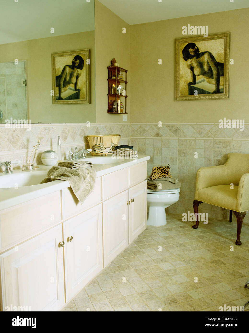 Doppi lavabi impostato in unità di credenza in bagno con pittura figurativa  sulla parete sopra wc e poltrona di colore giallo Foto stock - Alamy