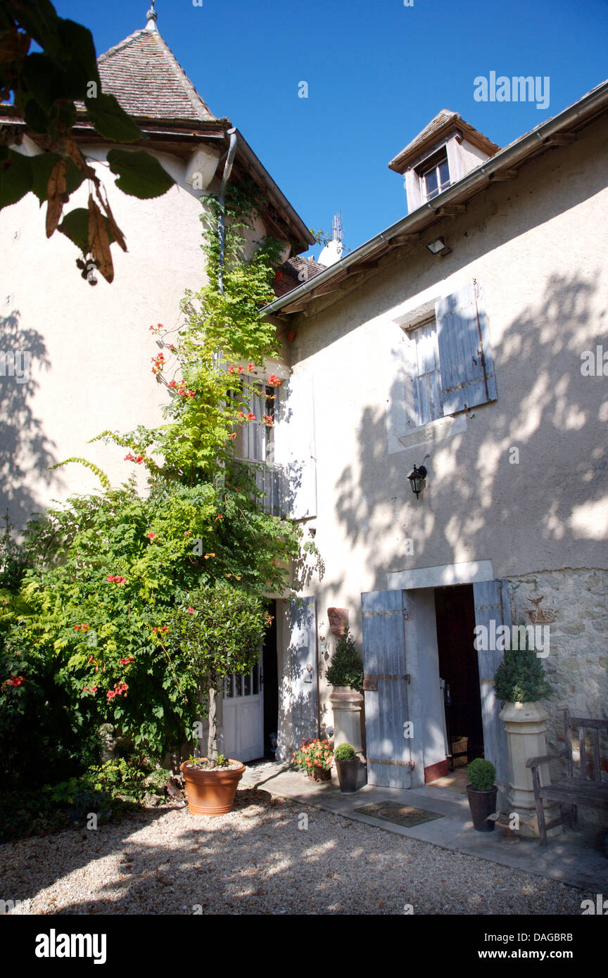 Cortile della casa francese di campagna con persiane colorate su porte e finestre Foto Stock