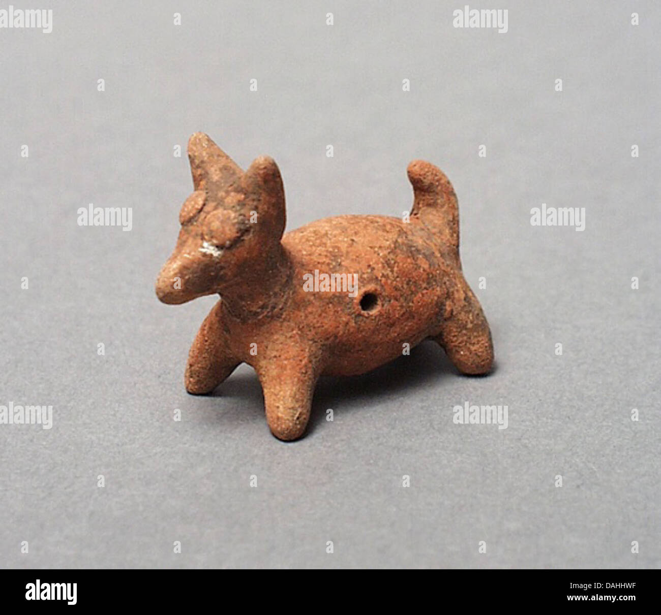 Una serie di figure di cane accompagnate da un fischio di cane, che illustrano antiche rappresentazioni culturali degli animali nell'arte e il loro uso pratico nella comunicazione o nei rituali. Foto Stock