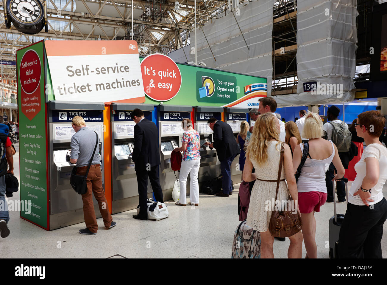 Coda di passeggeri al self service ticket macchine a Waterloo overground national rail stazione ferroviaria London, England Regno Unito Foto Stock