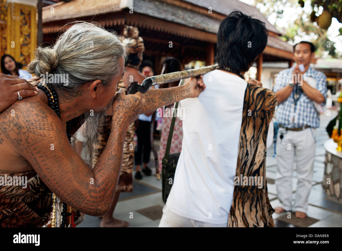 Pesantemente tatuato eremiti animista dire delle preghiere di guarigione e raccontare vicende a Doi Suthp tempio buddista in Chiang Mai, Thailandia. Foto Stock