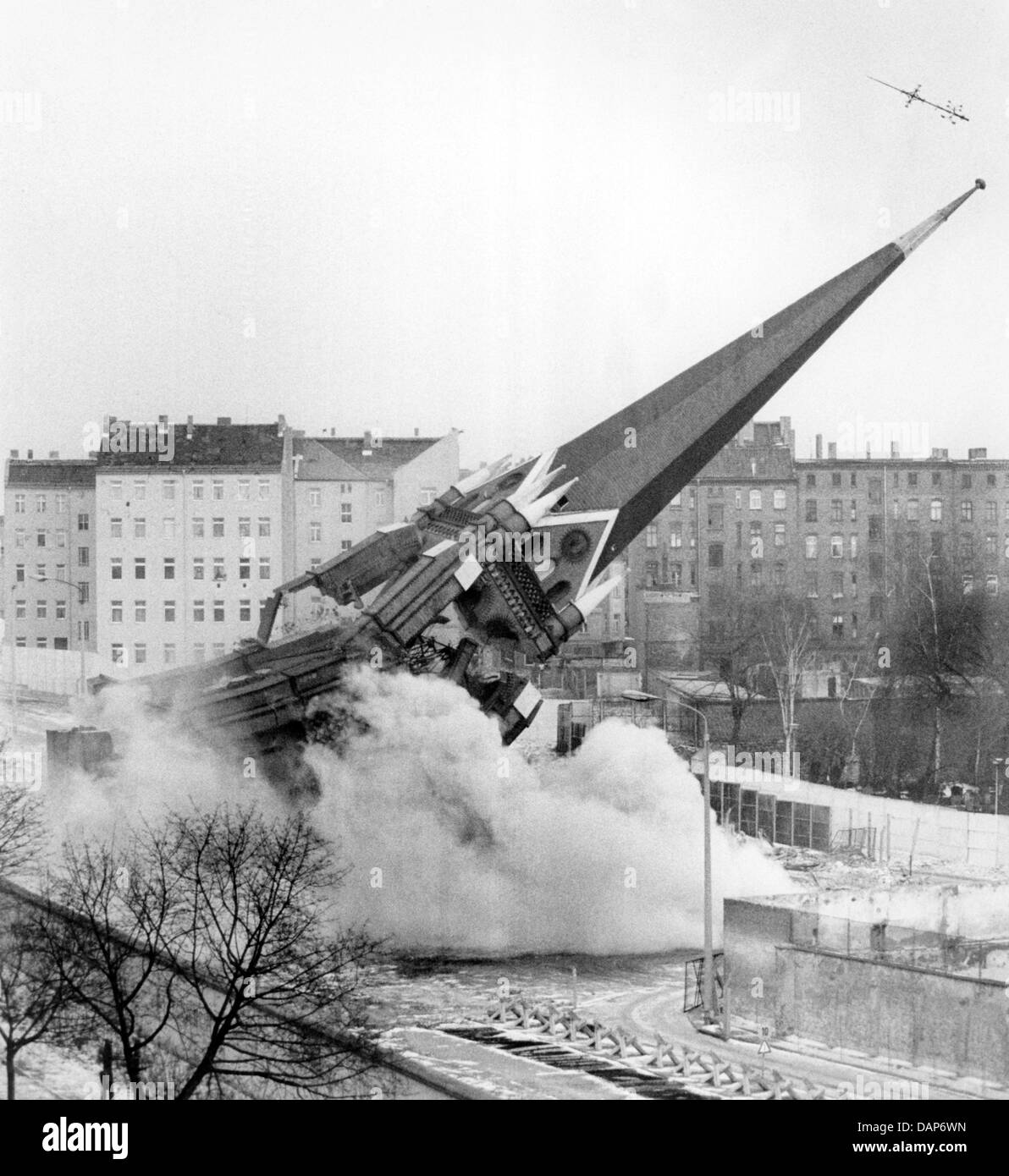 (Dpa) file - un file immagine datata 28 gennaio 1985 mostra l'esplosione della torre dell'Versoehnungskirche dietro il muro di Berlino nella ex Berlino Est, RDT (Berlino, Germania). Funzionari della RDT ordinò la demolizione per liberare la striscia della morte. Il 13 agosto 2011, il cinquantesimo anniversario della costruzione del muro di Berlino, la torre la croce sarà istituito presso la commemorazione del paesaggio Foto Stock