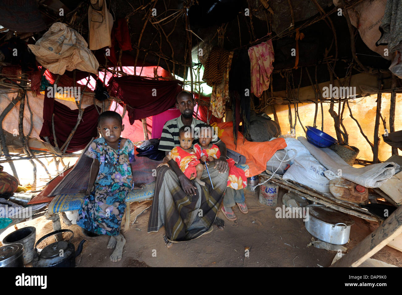 Con il suo childrean e tutte le famiglie averi intorno a lui questo rifugiati somali si siede nella sua tenda in un campo di rifugiati di Dadaab, Kenya 4 agosto 2011. Somalia e parti del Kenya è stata colpita da una delle peggiori le bozze e carestie in sei decenni, più di 350 000 profughi hanno trovato rifugio in mondi più grande campo di rifugiati. Foto: Boris Roessler Foto Stock