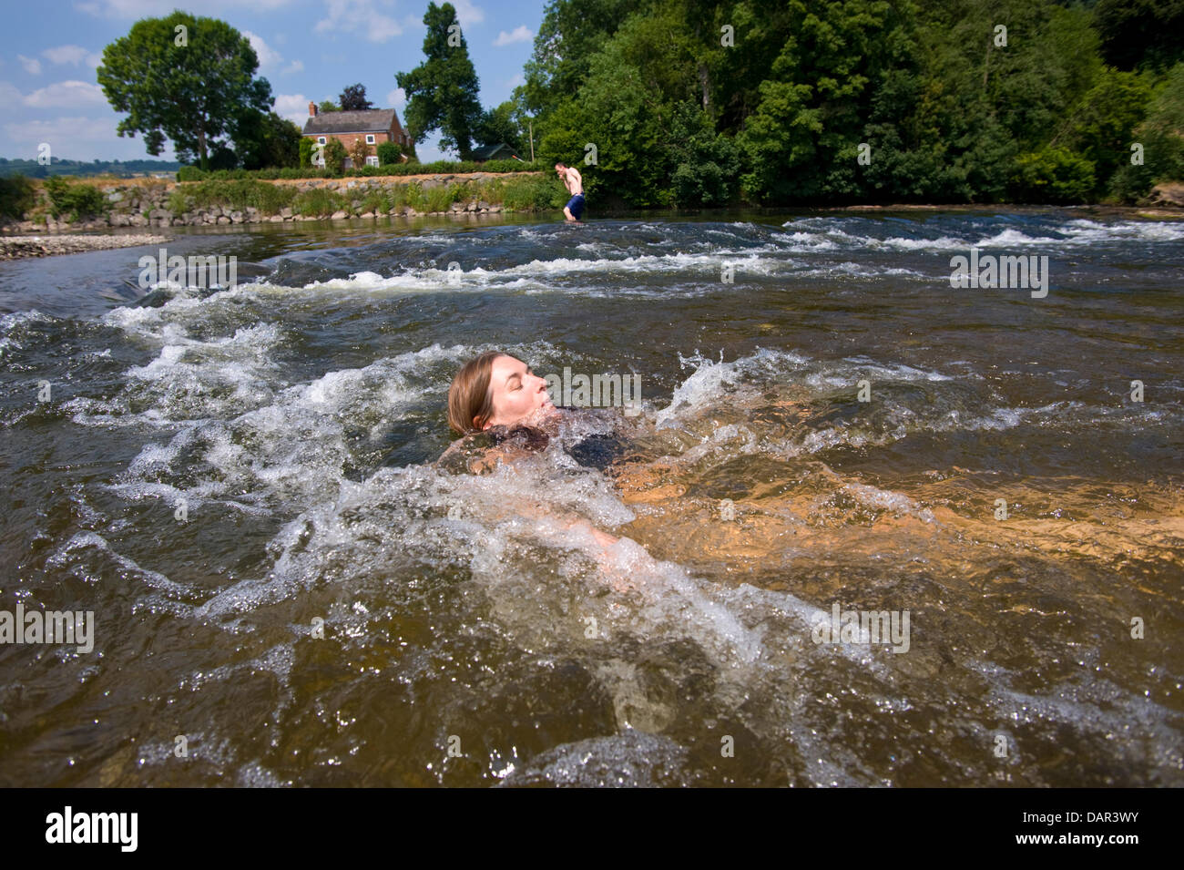 Come le temperature raggiungono 30ºC vacanziere Julie Burrows da Norfolk raffredda nel fiume Wye a Hay on Wye, Powys, Wales, Regno Unito Foto Stock