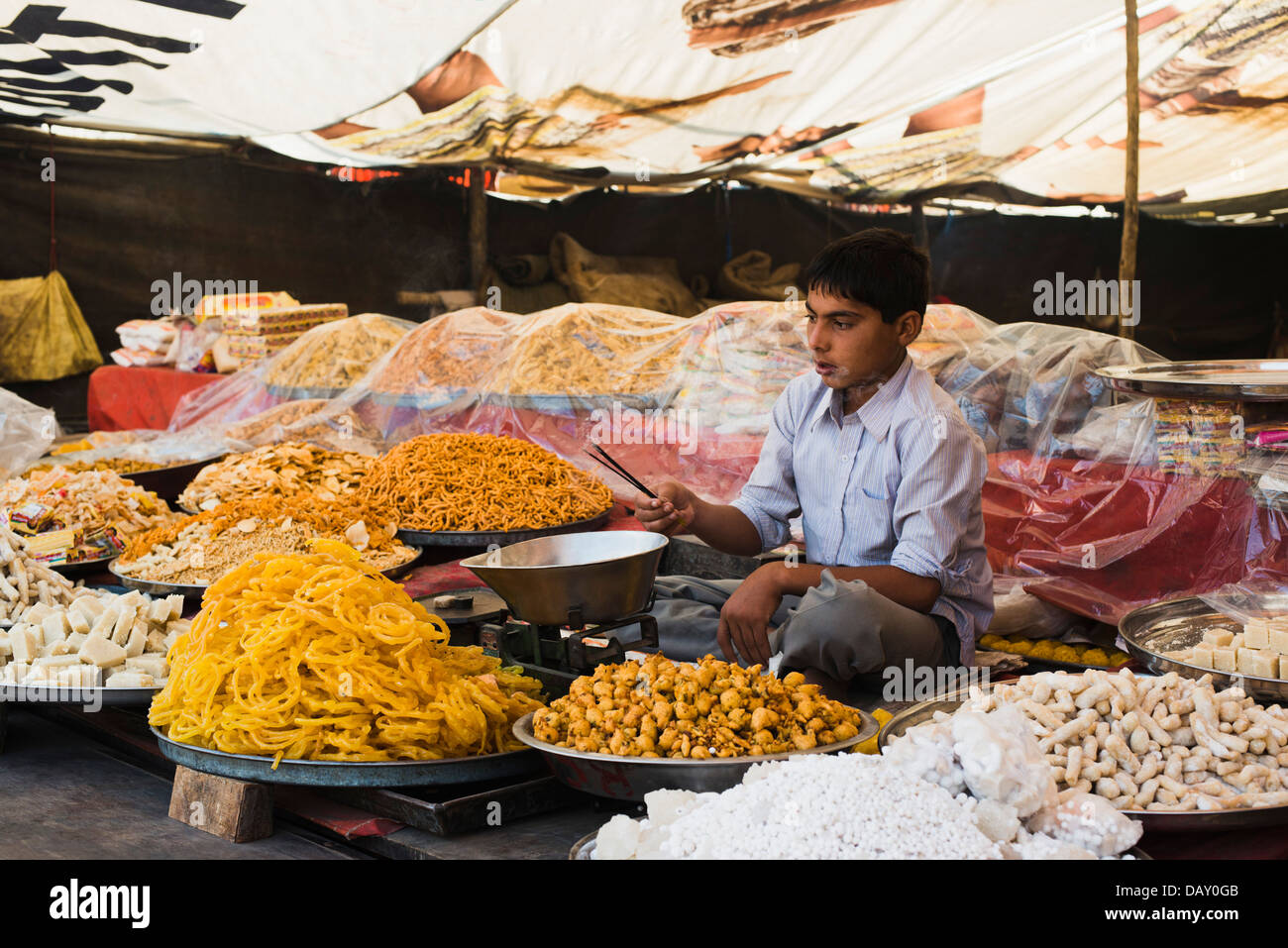 Ragazzo in un negozio di spuntini, Pushkar, Ajmer, Rajasthan, India Foto Stock