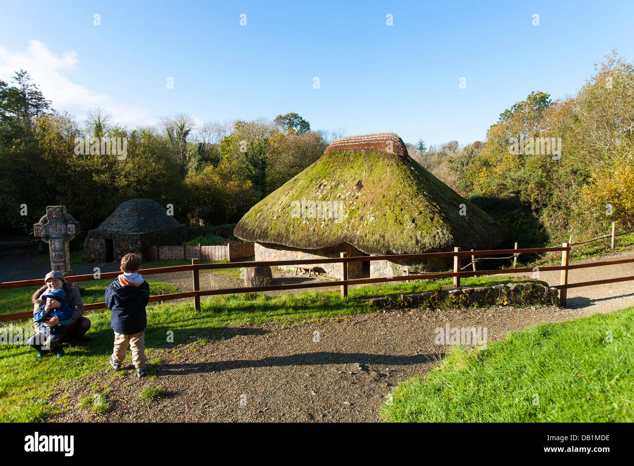 Visitare la famiglia ispezionare ricostruito cristiana dei primi insediamenti nella Irish National Heritage Park nel conteggio Wexford, Irlanda Foto Stock