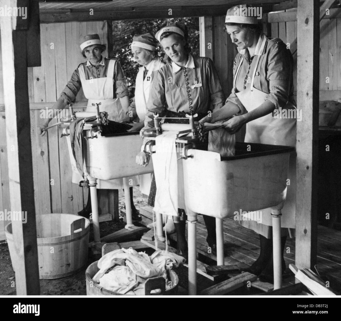 Famiglia, lavaggio, infermieri mettere lavanderia attraverso il mangle, 1940, Additional-Rights-Clearences-non disponibile Foto Stock