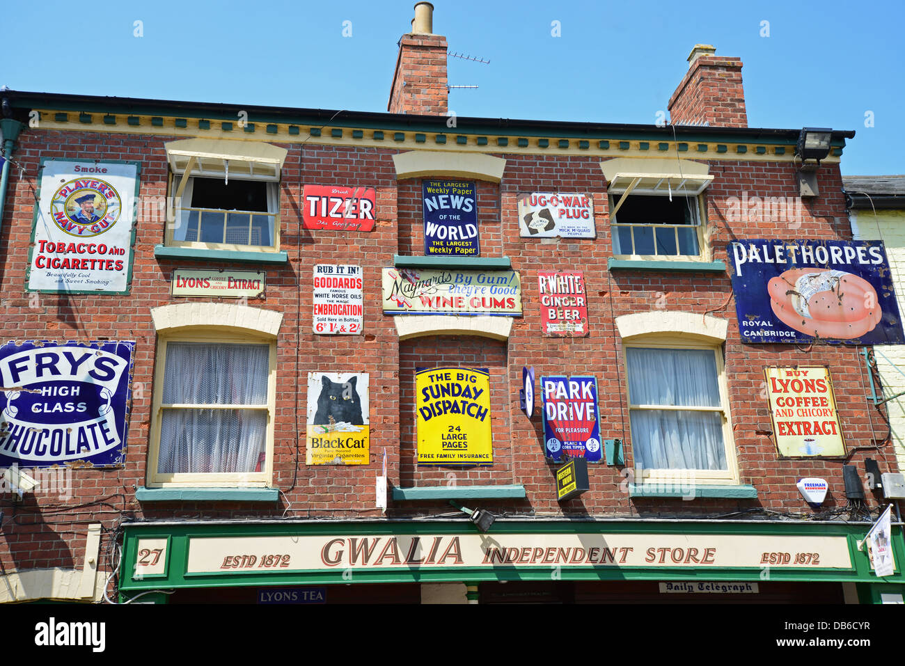 Smalto retrò lo stagno metallico cartelli pubblicitari sulla parte anteriore del negozio, Broad Street, Ross-on-Wye, Herefordshire, England, Regno Unito Foto Stock